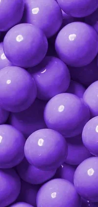 Looking for a whimsical and stylish addition to your phone's wallpaper? Check out this live wallpaper featuring a pile of purple candy in a ball pit along with fashionable accessories like lipstick, heels, and a dress