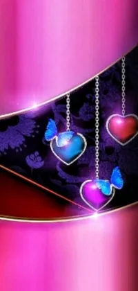 Get heart eyes with this stunning phone live wallpaper! The pink and black background serves as the perfect base for beautifully designed hearts hanging from chains, while glowing blue butterflies flutter around them