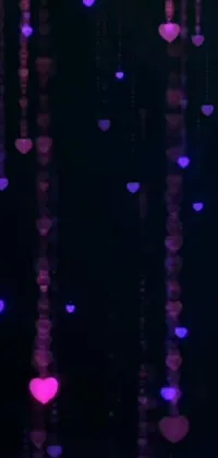 This live wallpaper features a charming array of hearts hanging from the ceiling in a room with a dark purple glowing background
