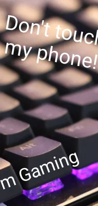 This phone live wallpaper features a close-up of a keyboard with the phrase &quot;don&#39;t touch my phone&quot; in bold letters
