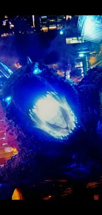 This phone live wallpaper features a fearsome godzilla standing in a destroyed city at night