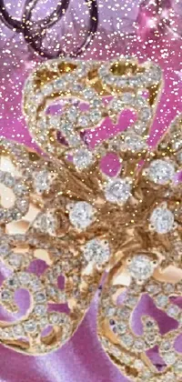 The phone live wallpaper features a close-up of a brooch with diamonds in a digital rendering, inspired by nature