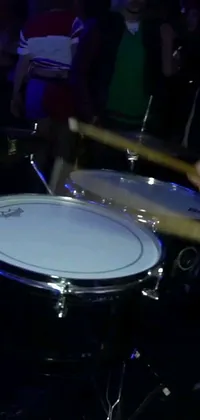 Enjoy the vibrant energy of this phone live wallpaper featuring a drum being played close up in a night club