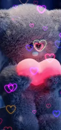 This phone live wallpaper features a charming teddy bear clasping a glowing heart against a picturesque backdrop
