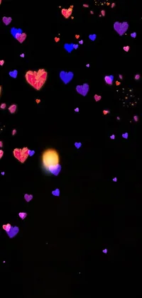 This live wallpaper displays a stunning design of hearts floating in the night sky