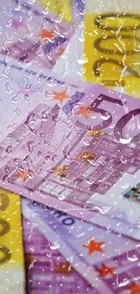 This phone live wallpaper features a colorful and highly detailed image featuring a pile of money on a wooden table, accompanied by a portrait and a blurred image of the European Union in the background