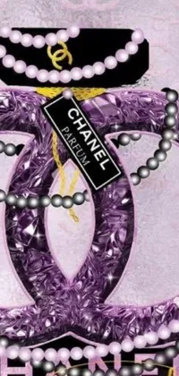 This phone live wallpaper features a stunning close-up of a pearl necklace on a purple cloth backdrop