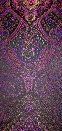 Add some color and personality to your phone's background with this stunning paisley live wallpaper! The intricate design showcases shades of purple and black in a traditional arabesque or brocade pattern, with pops of modern pink that really make it stand out