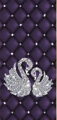 This phone live wallpaper depicts a pair of swans resting on a luxurious purple quilt, embellished with shimmering jewels