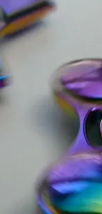 This live wallpaper features a colorful fidget spinner on a tungsten purple background