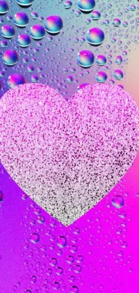 This phone live wallpaper features a pink heart surrounded by water droplets in a cosmic sea of abstract colors and textures