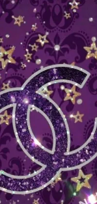 This live wallpaper for your phone provides a captivating and dreamy ambiance with a purple background adorned with twinkling stars and the instantly recognizable Chanel logo at the center