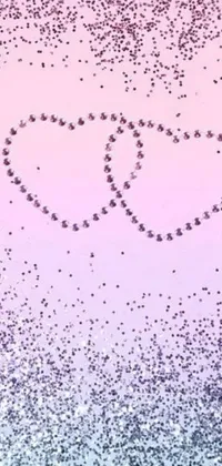 Looking for a romantic live wallpaper for your phone? Check out this heart-filled design featuring two hearts drawn in the sand on a pink and blue background with purple sparkles and crystal embellishments
