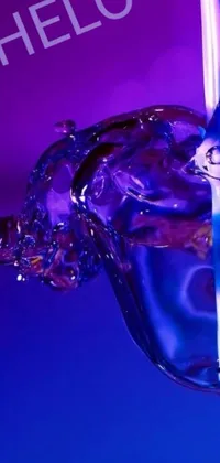 This phone live wallpaper boasts a stunning digital art design featuring blue liquid pouring into a glass, surrounded by vibrant colors and ripples