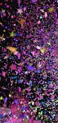 This phone live wallpaper features a festive animation of colorful confetti against a cosmic purple space background in a microscopic photo effect