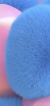 This live wallpaper showcases a charming display of blue fluffy balls, each with their own unique texture, stacked atop one another against a soft pink background