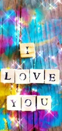 This live phone wallpaper features a charming wooden sign adorned with the adorable message of "I Love You