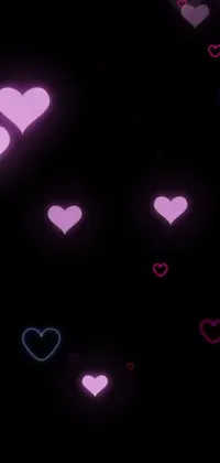 This digital phone wallpaper features a black background adorned with various colorful hearts