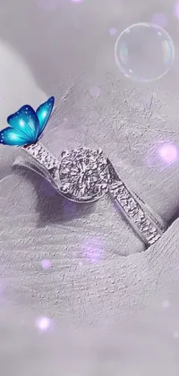 This live wallpaper showcases a beautiful blue butterfly sitting on a white cloth against an L