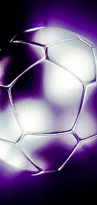 This phone live wallpaper features a close-up of a shiny white metal soccer ball on a black background