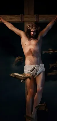 This phone live wallpaper portrays a man on a wooden cross, with arms and legs hanging down, against a photorealistic backdrop