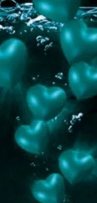 This live wallpaper showcases heart-shaped balloons floating in sparkling teal water