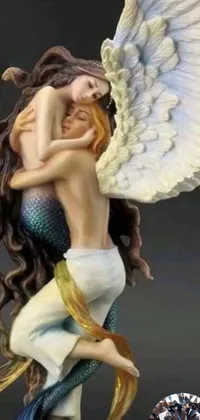 Looking for a stunning live wallpaper for your phone? Look no further than this exquisite statue of an angel hugging a mermaid, featuring beautiful wings and intricate details