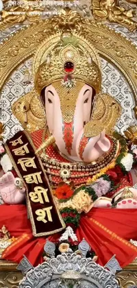 This striking live phone wallpaper features a close-up view of a majestic elephant statue draped in colorful red and gold cloth, as well as white and pink fabric, giving the image a vibrant and regal feel