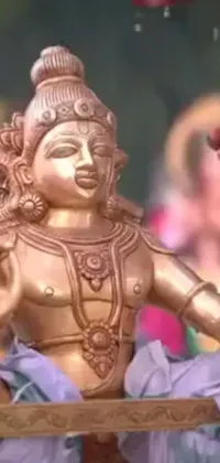 This phone live wallpaper features a close-up of a statue inspired by a spiritual scene