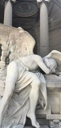 This striking phone live wallpaper features a close up of a statue of an angel in distress