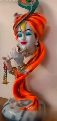 This captivating live wallpaper features a stunning statue of a woman with distinctive orange hair