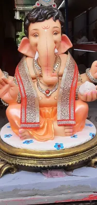 This live wallpaper features a beautifully crafted elephant statue sitting atop a table