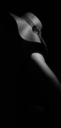 This black and white phone live wallpaper depicts a striking woman wearing a hat, composed in perfect silhouette