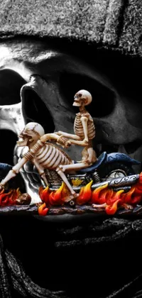 This smartphone live wallpaper features a menacing skeleton straddling a motorcycle in full speed, surrounded by fiery flames