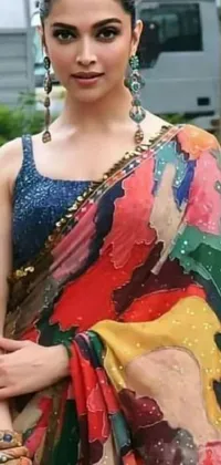 This phone live wallpaper displays a woman dressed in a colorful sari, posing for the camera in close-up
