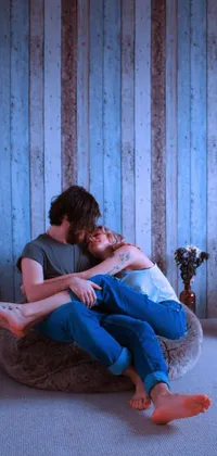 Decorate your mobile phone with this lovely live wallpaper of a man and woman embracing in a cozy blue room