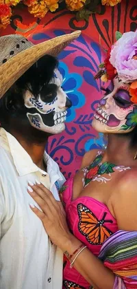 This phone live wallpaper features a colorful scene of a man and woman in day of the dead costumes