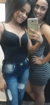 This phone live wallpaper depicts two women taking a selfie in front of a mirror