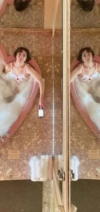 This phone live wallpaper features a relaxing scene with a woman taking a bath in a heart-shaped tub surrounded by playful items such as floating perfume and colorful objects like flamingos and planets