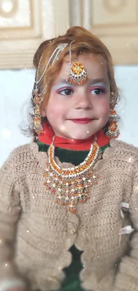 This live wallpaper features a colorful close up photo of a child in a gorgeous costume and festive clothing