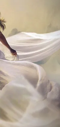 This live wallpaper for your phone showcases a stunningly realistic painting of a woman in a flowing white dress, soaring through the air with diaphanous iridescent cloth shimmering in the sunlight