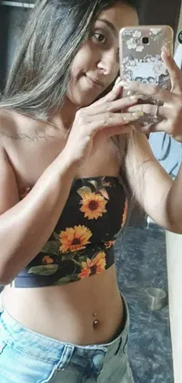 This phone live wallpaper showcases a stunning artwork of the tachisme style, featuring a woman taking a mirror selfie while posing in a bra amidst a floral background