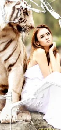 This mobile wallpaper showcases a stunning still of a woman seated by a captivating white tiger