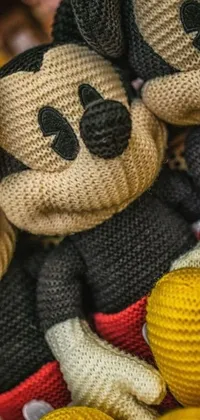This phone live wallpaper showcases a group of stuffed Mickey Mouse toys sitting together