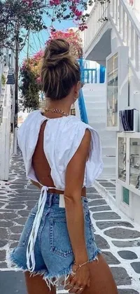 Introducing a stunning phone live wallpaper of a young woman strolling through a picturesque cobblestone street
