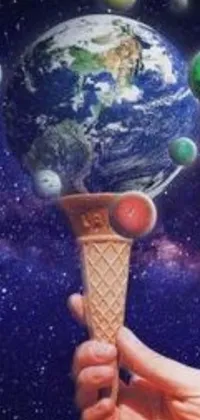 This dynamic phone live wallpaper showcases an ice cream cone being held by a serene hand against a background of mesmerizing planets and ascending universes