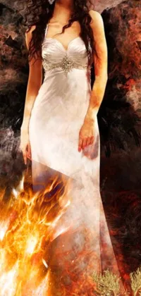 This phone live wallpaper captures an intense moment of a woman standing in front of a raging fire
