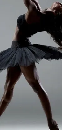This stunning live wallpaper features a dark-skinned woman in a tutu performing a beautiful jump