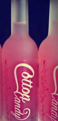 This lively live wallpaper showcases three pink soda bottles placed next to each other, providing a pop of color to any phone screen