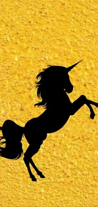 This captivating live wallpaper features a striking silhouetted unicorn standing on its hind legs against a cave painting backdrop